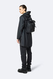 Rains Roll Top Mini Backpack Black model man zijkant